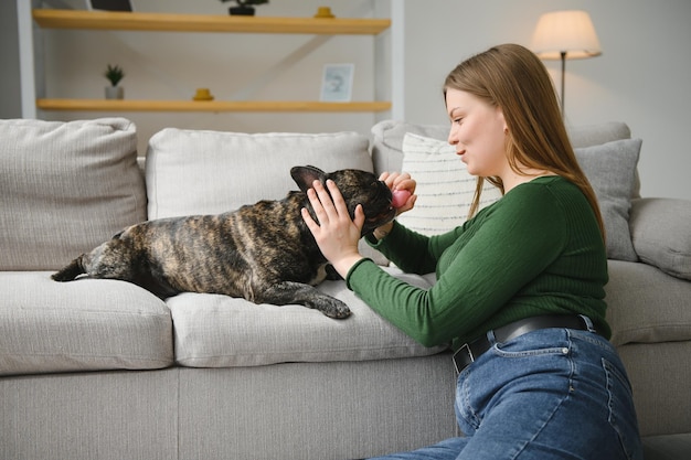 Young woman with her dog at home lovely pet