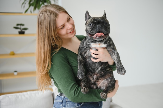 Young woman with her dog at home Lovely pet