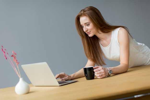 Young woman with laptop in the office