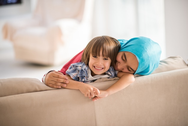 Young woman with little kid at home