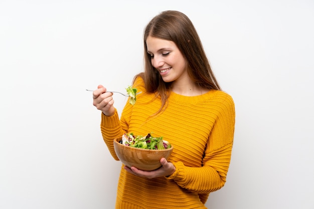 Young woman with long hair with salad