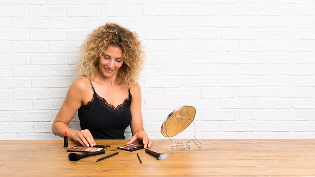 Young woman with lots of makeup brush in a table