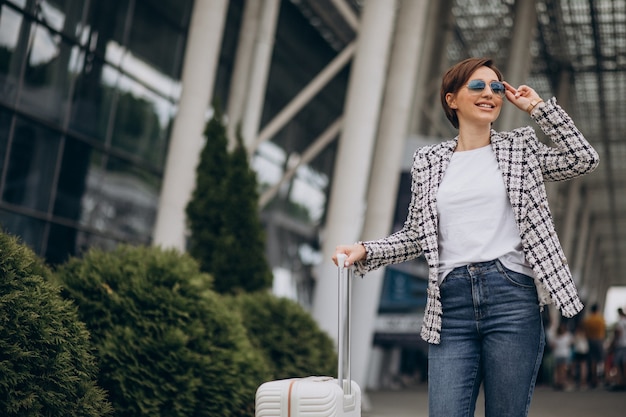 Young woman with luggage at airport travelling