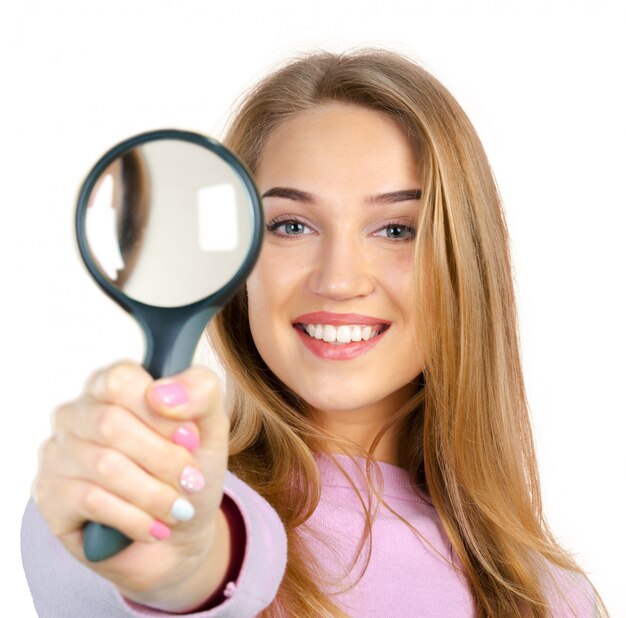 Young woman with magnifying glass