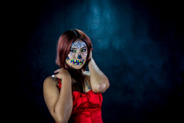 Young woman with makeup for halloween party costume party black background and red blouse