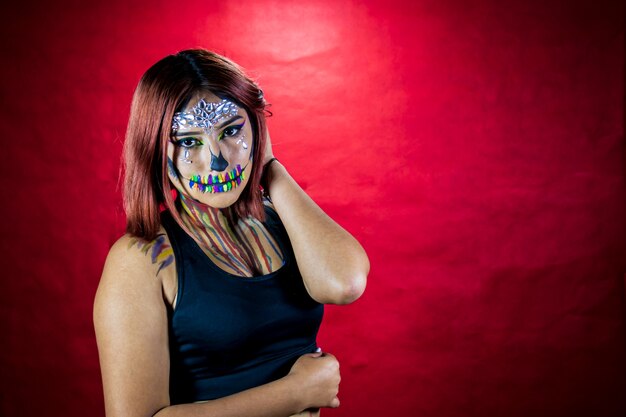 Young woman with makeup for halloween party costume party red background