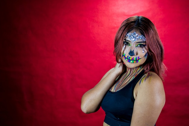 Young woman with makeup for halloween party costume party red background