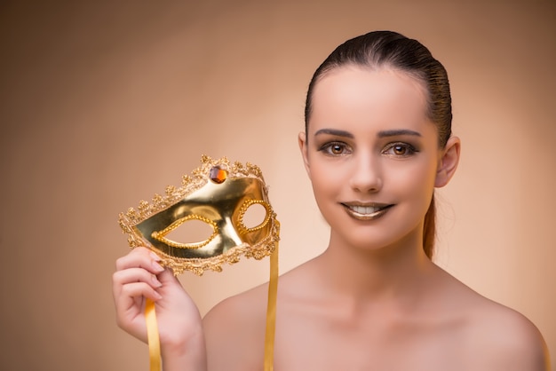 Young woman with mask in carnival concept