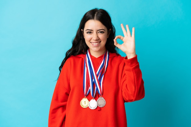 Young woman with medals isolated
