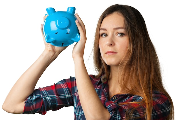 白で隔離される貯金箱を持つ若い女