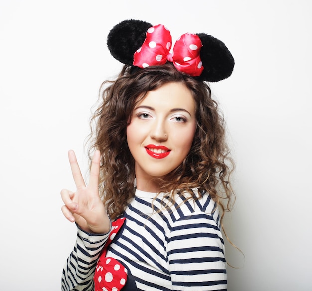 Photo young woman with mouse ears over white background