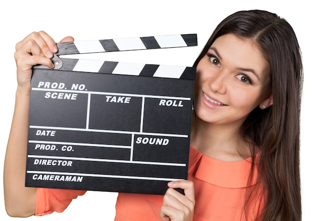 Young woman with movie clapper isolated on white