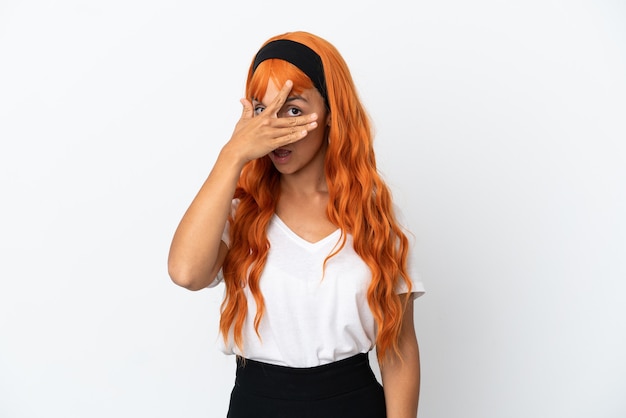 Young woman with orange hair isolated on white background covering eyes by hands and smiling