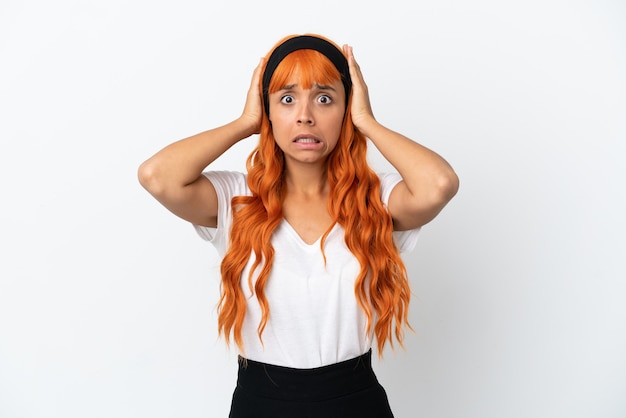 Young woman with orange hair isolated on white background doing nervous gesture