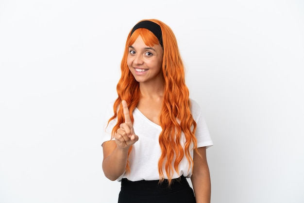 Young woman with orange hair isolated on white background showing and lifting a finger