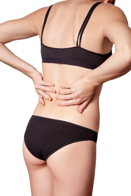 Young woman with pain in back on white background