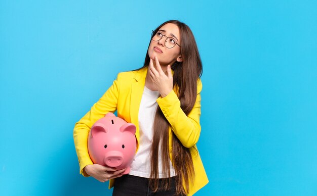 young woman with a piggy bank