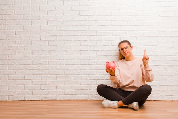 Young woman with a piggy bank