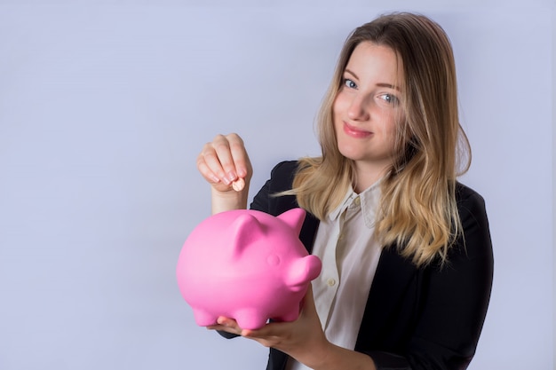 Young woman with piggy bank