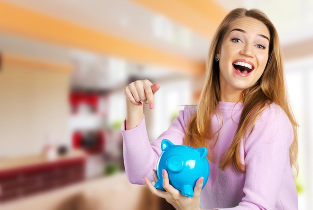 Young woman with piggy bank