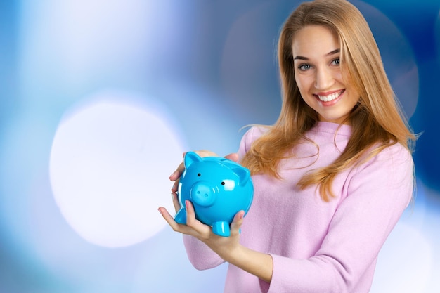 Young woman with piggy bank