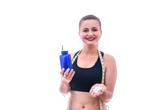 Young woman with pills in bottle isolated on white