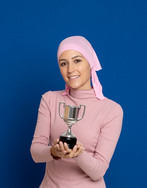 Young woman with pink scarf on the head on a blue