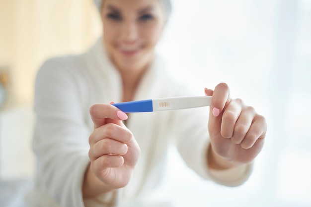 Young woman with pregnancy test