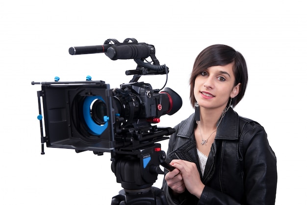 Young woman with professional video camera, SLR, on white