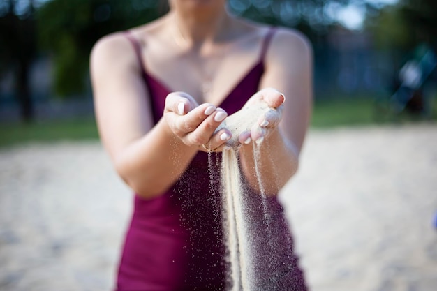 Young woman with sand in hands