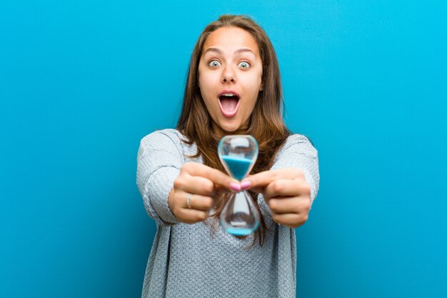 Young woman with sand timer 