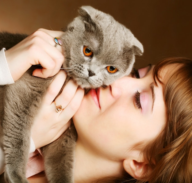 Young woman with scottish-fold cat 