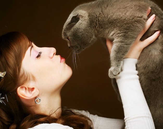 Young woman with scottish-fold cat 