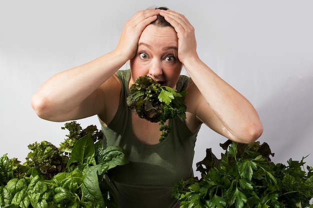 Foto giovane donna con una serie di ingredienti verdi lattuga spinaci per una dieta sana