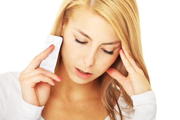 a young woman with severe headache over white background