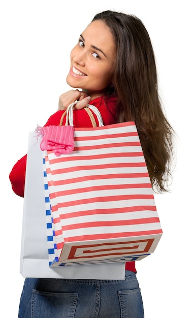 Young woman with shopping bags on  background