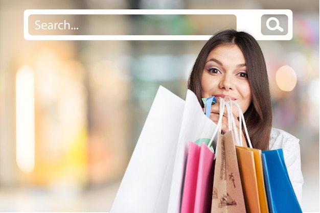 Young woman with shopping bags on  background