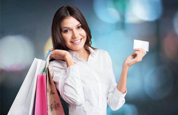 Young woman with shopping bags on  background