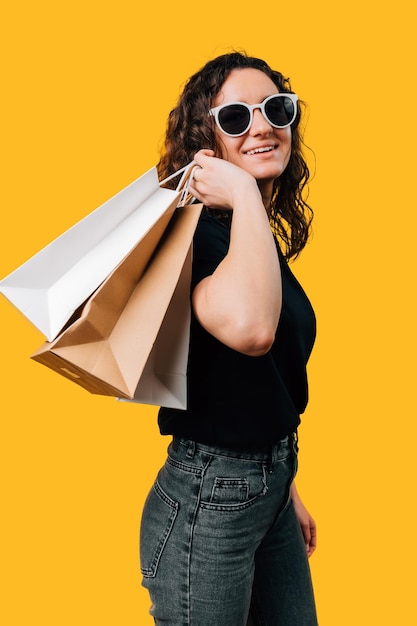 young woman with shopping bags embracing the joy of buying