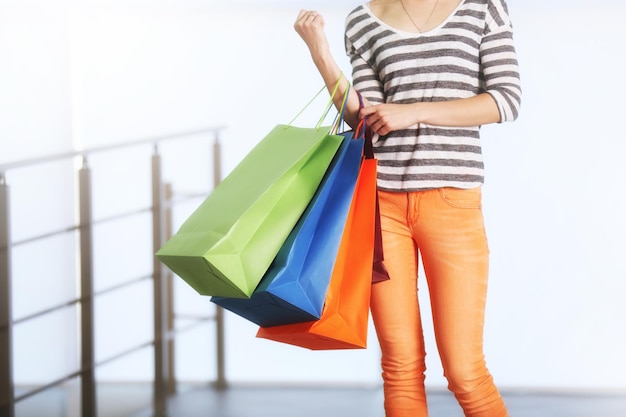 Young woman with shopping bags in the mall