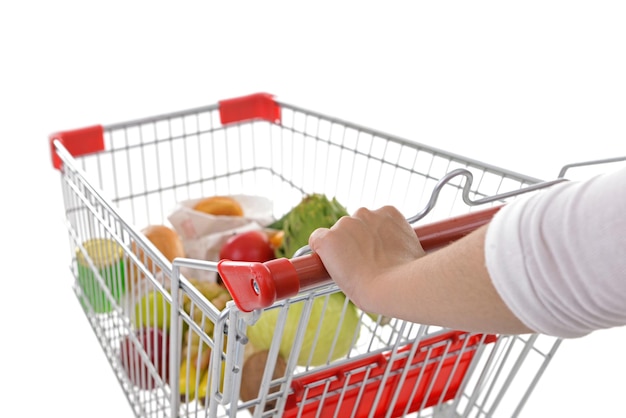 Young woman with shopping cart isolated on white