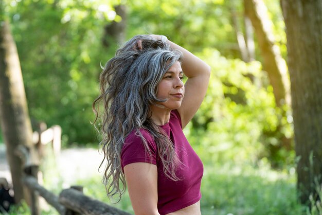 Young woman with silver gray hair touching her hair