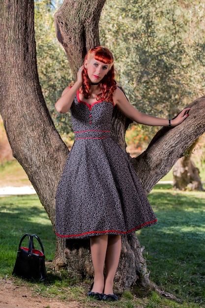 Young woman with a simple spring dress posing on the park