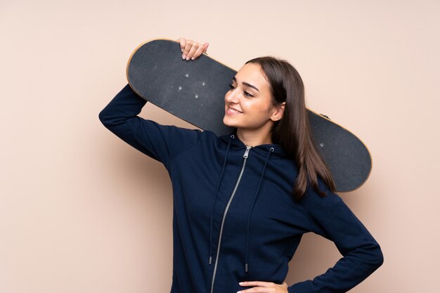 Young woman with skate and looking side