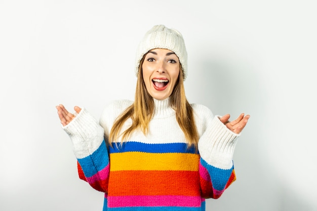 Young woman with a smile in a hat and sweater isolated