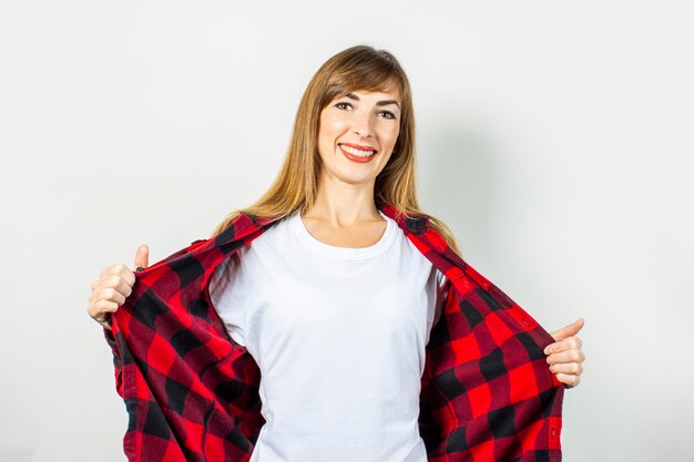 Photo young woman with a smile in a red shirt and white t-shirt