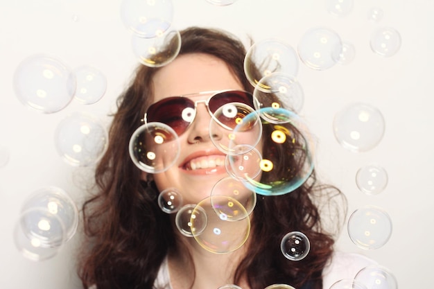 Young woman with soap bubbles