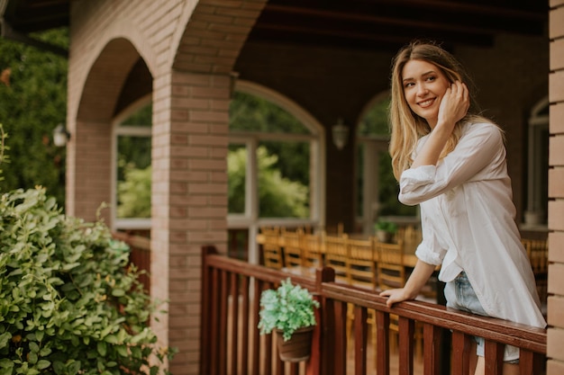 Young woman with standing on the terrace