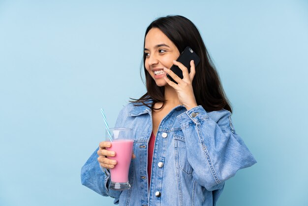 Young woman with strawberry milkshake isolated