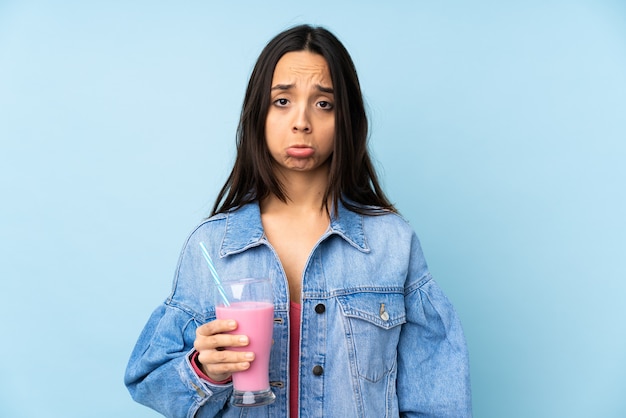 Young woman with strawberry milkshake isolated